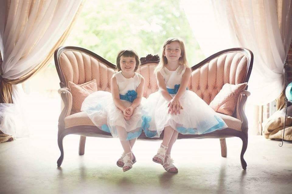 Flower girls seated on a couch