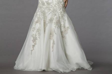 Style 32838237  This mermaid gown features a strapless neckline with a dropped waist in beaded embroidery and tulle. It has a chapel train. This gown is Exclusive to Kleinfeld Bridal.