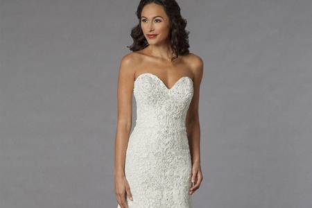 Style 32851669  This mermaid gown features an high neck neckline with a dropped waist in lace and satin. It has a chapel train and cap sleeves. This gown is Exclusive to Kleinfeld Bridal.