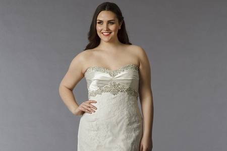 Style 32745333  This sheath gown features a sweetheart neckline with an empire waist in lace and beaded embroidery. It has a sweep train. This gown is available in Plus Sizes, and is Exclusive to Kleinfeld Bridal.