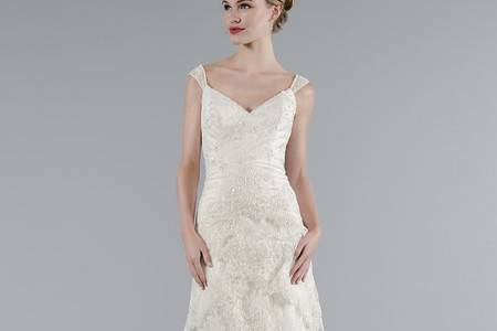 Style 33012071  This sheath gown features a v-neck neckline with in lace. It has a chapel train and cap sleeves. This gown is Exclusive to Kleinfeld Bridal.