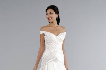 Style 33012097  This a-line gown features a tip of the shoulder neckline with a basque waist in silk taffeta. It has a chapel train. This gown is Exclusive to Kleinfeld Bridal.