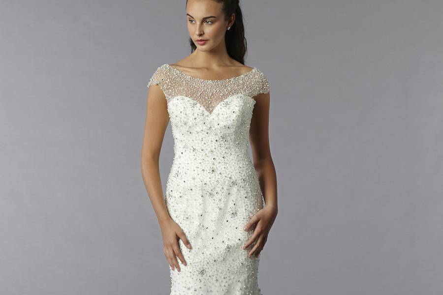 Style 32780785This mermaid gown features an illusion neckline with in beaded embroidery. It has a chapel train and cap sleeves. This gown is Exclusive to Kleinfeld Bridal.