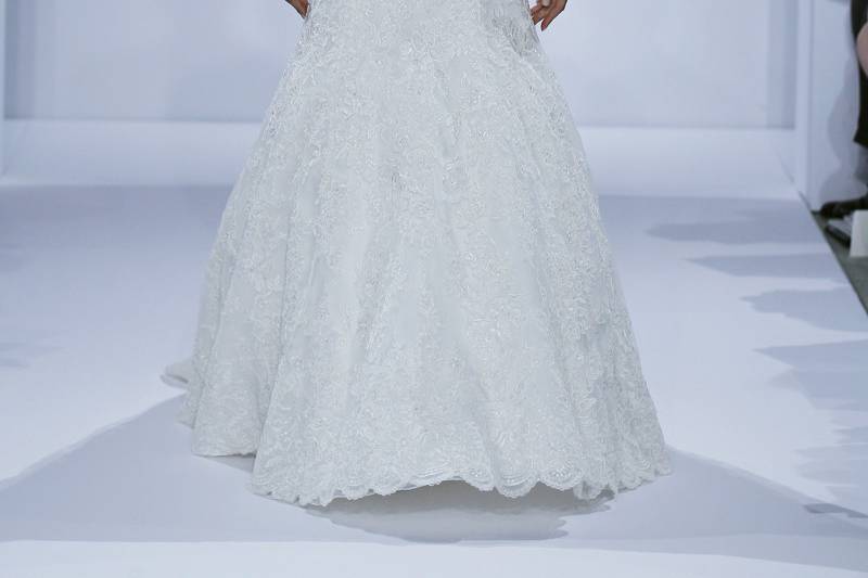 Style 32807638  This mermaid gown features a bateau neckline with a dropped waist in lace. It has a chapel train and long sleeves. This gown is Exclusive to Kleinfeld Bridal.