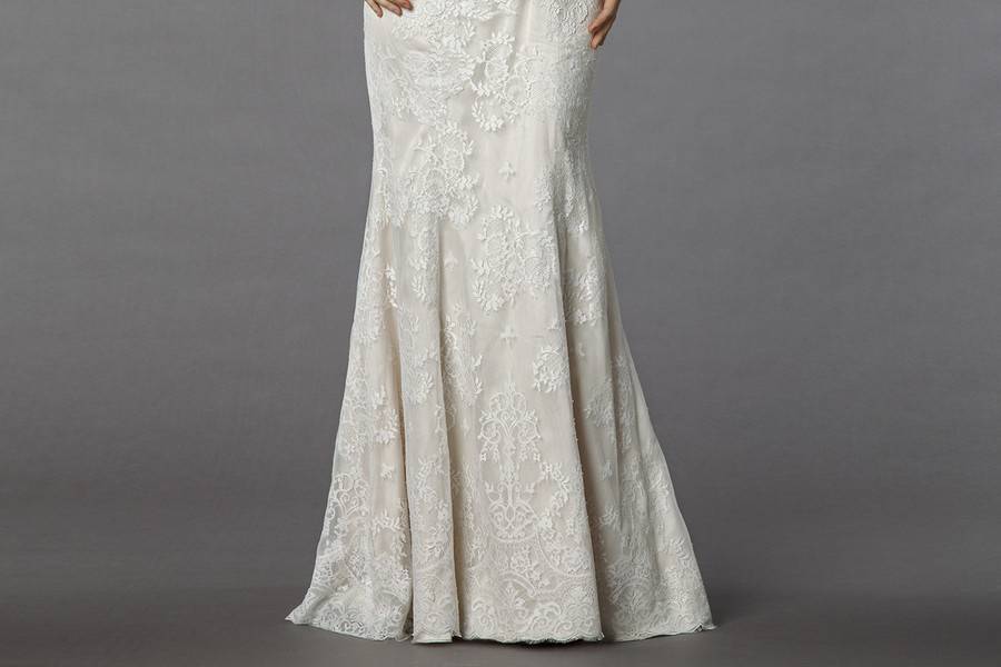 Styl 32950230  This mermaid gown features an high neck neckline with a dropped waist in lace and satin. It has a chapel train and 3/4 length sleeves. This gown is Exclusive to Kleinfeld Bridal.