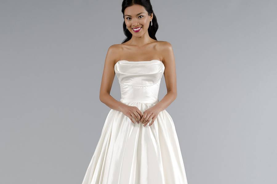 Style 32929770 This a-line gown features a strapless neckline with a natural waist in satin. It has a chapel train. This gown is Exclusive to Kleinfeld Bridal.