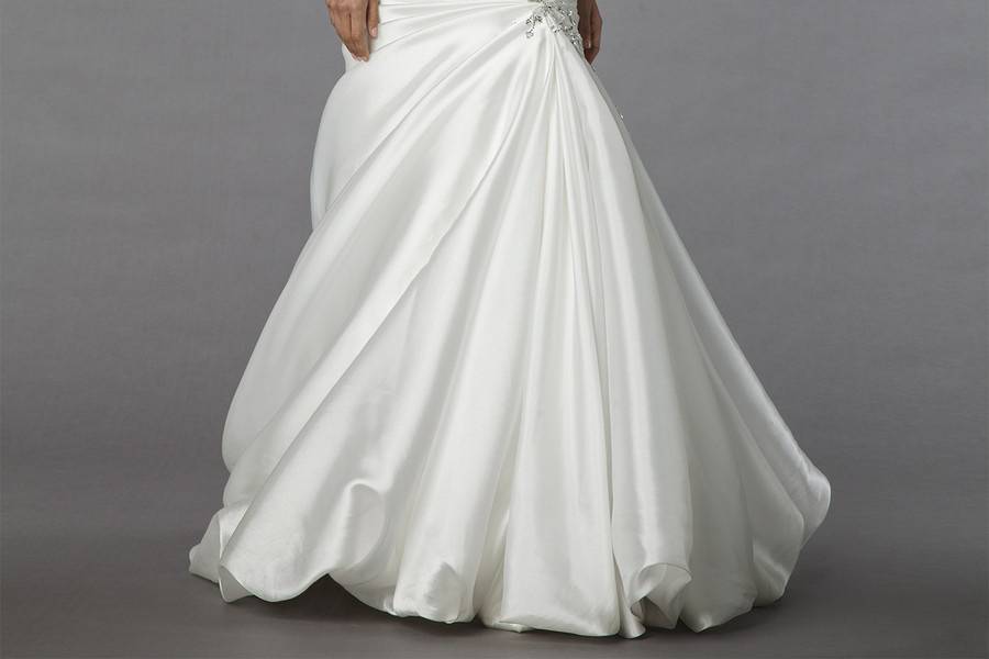 Style # 32848236This mermaid gown features a sweetheart neckline with a dropped waist in silk satin and beaded embroidery. It has a chapel train. This gown is Exclusive to Kleinfeld Bridal.