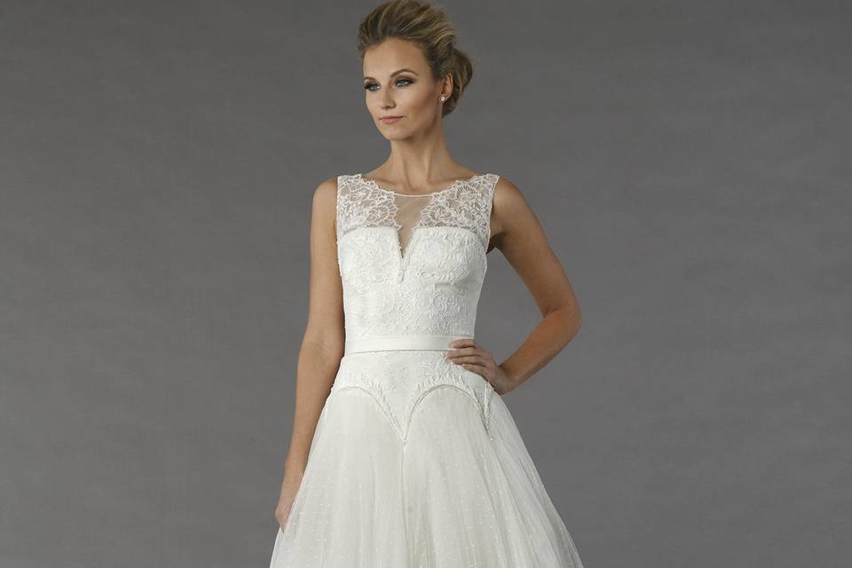 Tony Ward Bleuetta		This a-line gown features an illusion neckline with a natural waist in tulle and beaded embroidery. It has a chapel train.