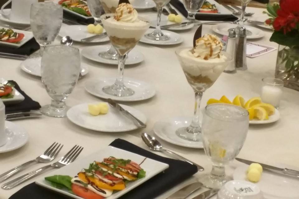 Caprese Salad and Caramel Apple Mousse served in a Martini Glass. This is a typical setting for a plated meal