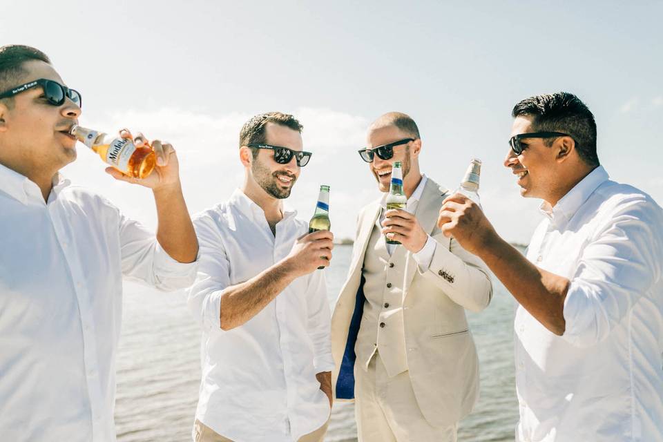 Groom sharing beers with his groomsmen