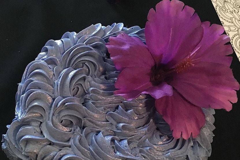Icing detailing and purple flower