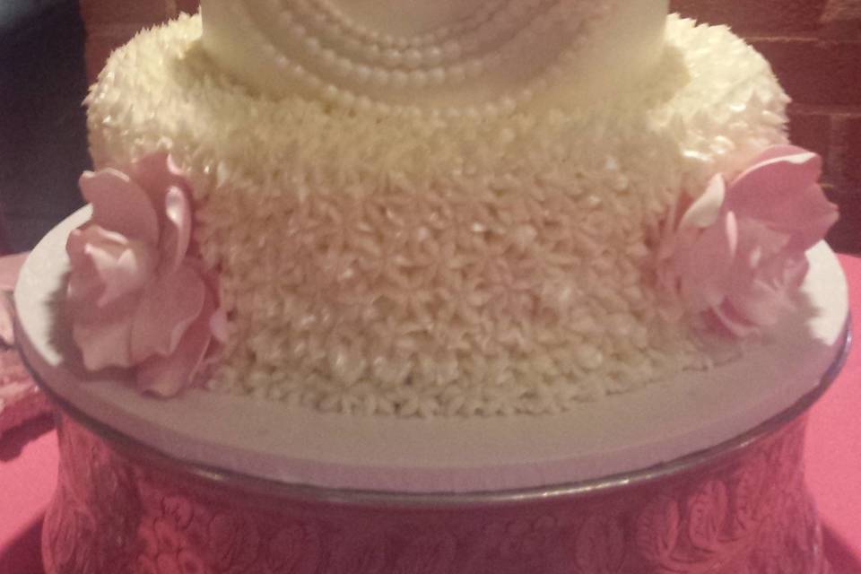 Four tier cake with pink flowers
