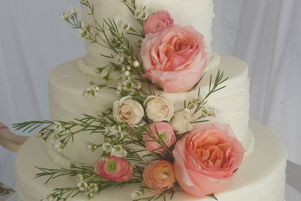 Three tier wedding cake with peach flowers