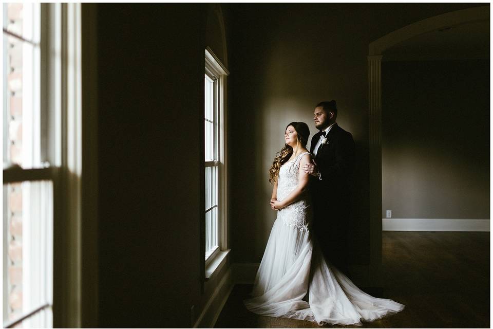 Newlyweds by a window