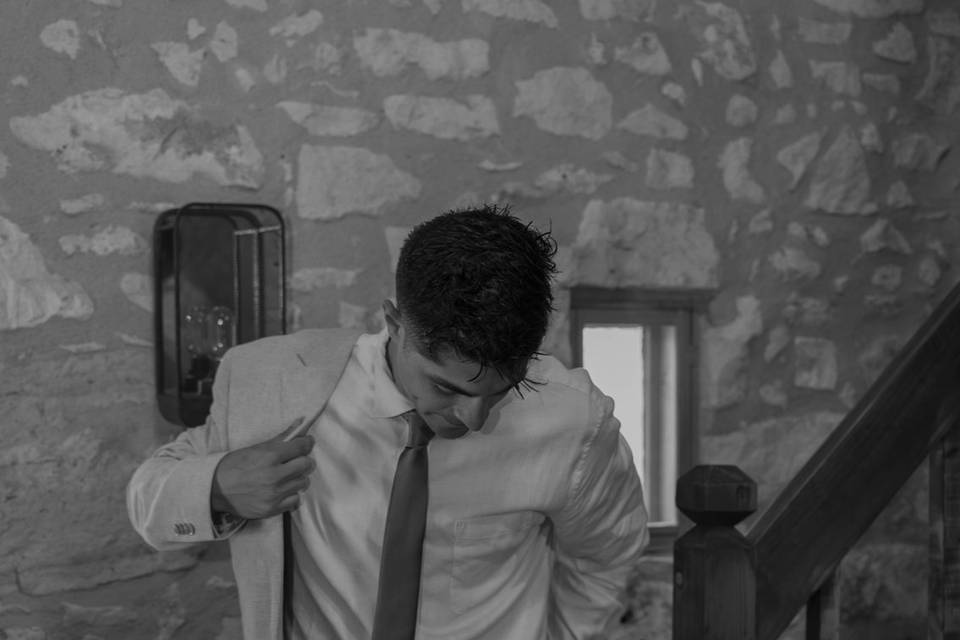 Groom Getting Ready in Barn