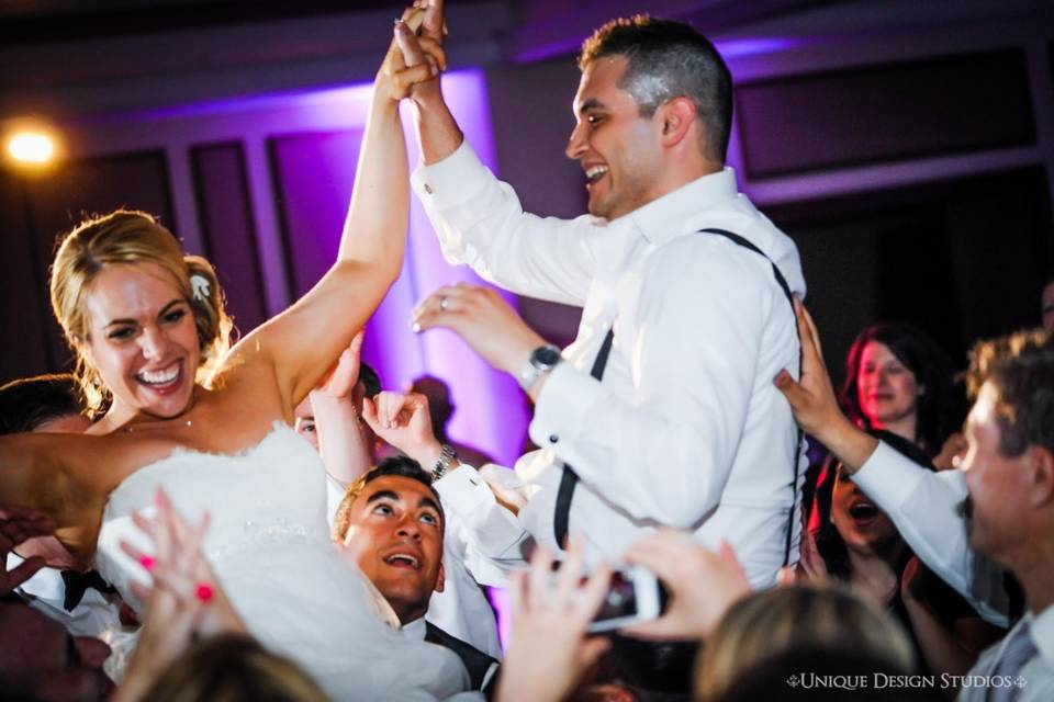 The couple dancing with guests