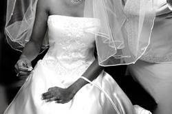Bride's mother helps her with her veil as she gets ready