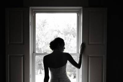 Silhouette of bride in window
