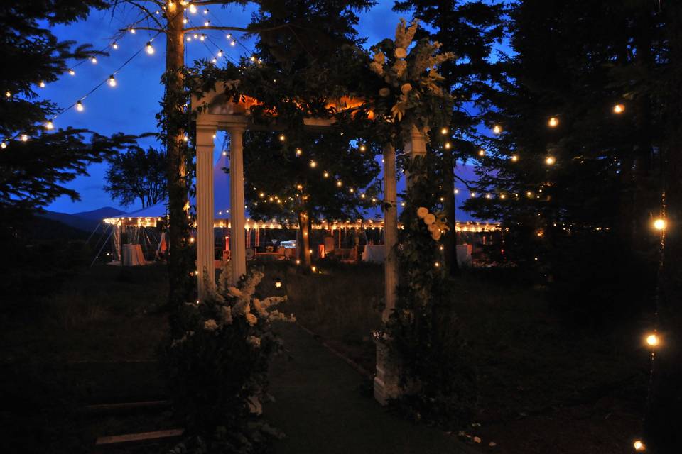 Café lights hung throughout the trees for the walk through the woods to cocktail tent