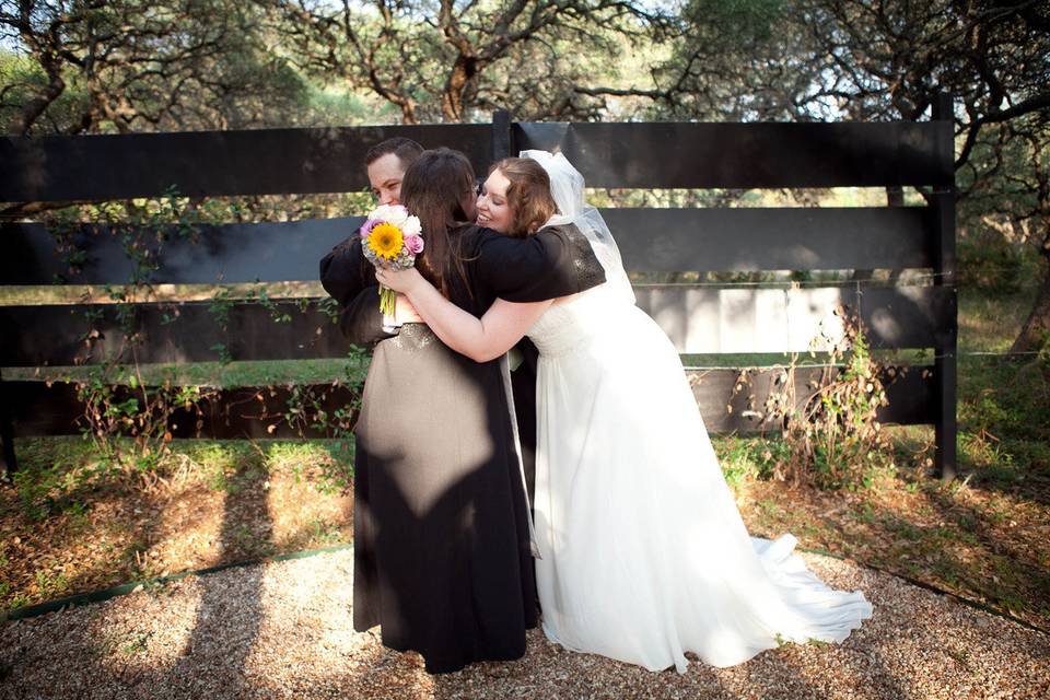 Reverend hugging the newlyweds
