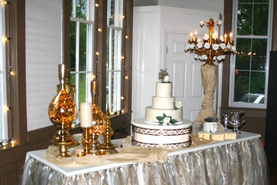 This was a summer reception held at a historic school house. We love this venue...   it is a fabulous canvas.  This bride wanted gold and glitz and glam, and everything turned out gorgeous.  This table features our tutu skirt, Italian rose chandelier, and gold mercury glass.