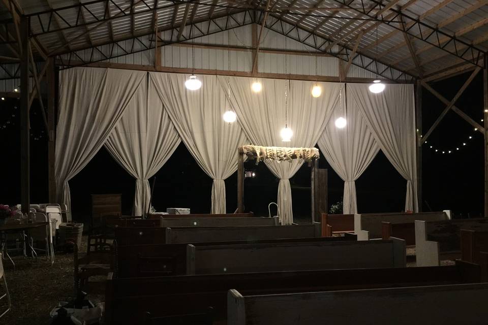 W.I.L.L.O.W. transformed a hay barn that belongs to this bride's grandfather.  We made 34' canvas curtains, brought in 30 vintage church pews, and used barn doors, assorted vintage doors, vintage lighting and chandeliers, farm tables, ladder back chairs, an antique farm wagon and numerous additional items to create her vision.