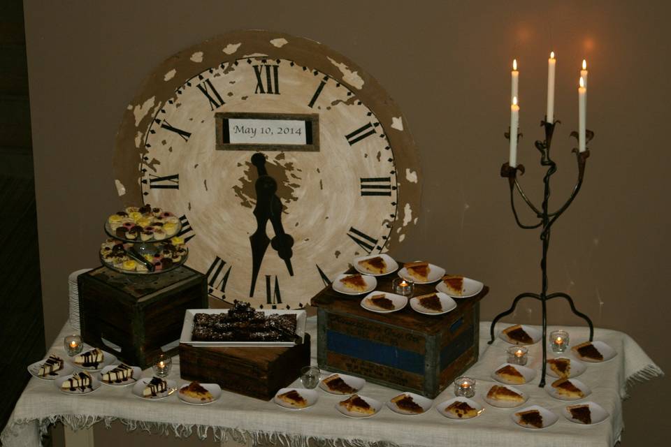 We did the rehearsal dinner for this bride and groom.  We used vintage crates and our oversized clock for the dessert bar.