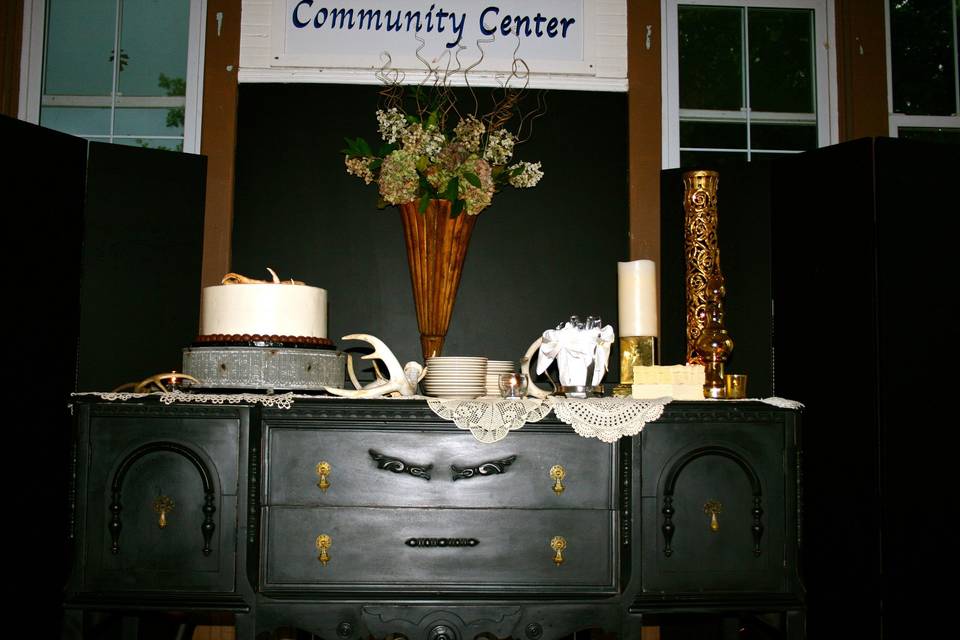 This was a summer reception held at a historic school house. We love this venue...   it is a fabulous canvas.  This bride wanted gold and glitz and glam, and everything turned out gorgeous.  We used our vintage black buffet for serving the groom's cake.