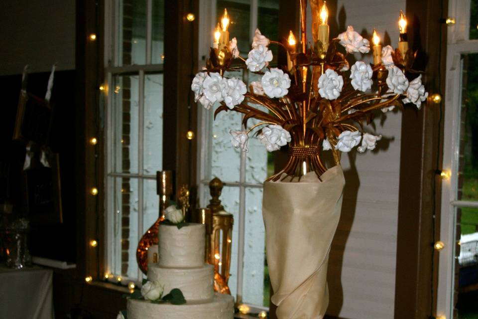 This was a summer reception held at a historic school house. We love this venue...   it is a fabulous canvas.  This bride wanted gold and glitz and glam, and everything turned out gorgeous.  This table features our tutu skirt, Italian rose chandelier, and gold mercury glass.