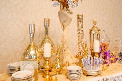 This is a Gatsby-themed gold and glamourous reception!  We had a 16' dessert bar featuring our tutu skirt, mirrored cake stand, rose chandelier, and lots of gold mercury glass.