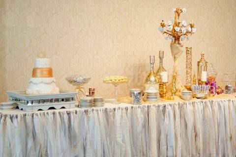 This is a Gatsby-themed gold and glamourous reception!  We had a 16' dessert bar featuring our tutu skirt, mirrored cake stand, rose chandelier, and lots of gold mercury glass.