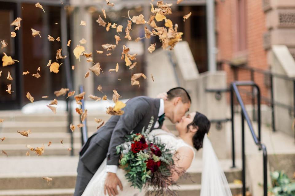 Bride and groom dip and kiss