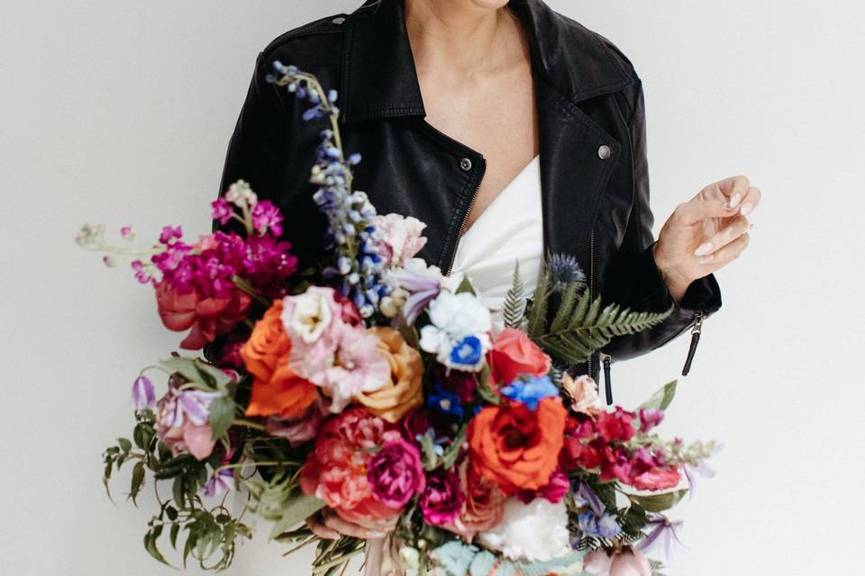 Bride with flowers, white wall