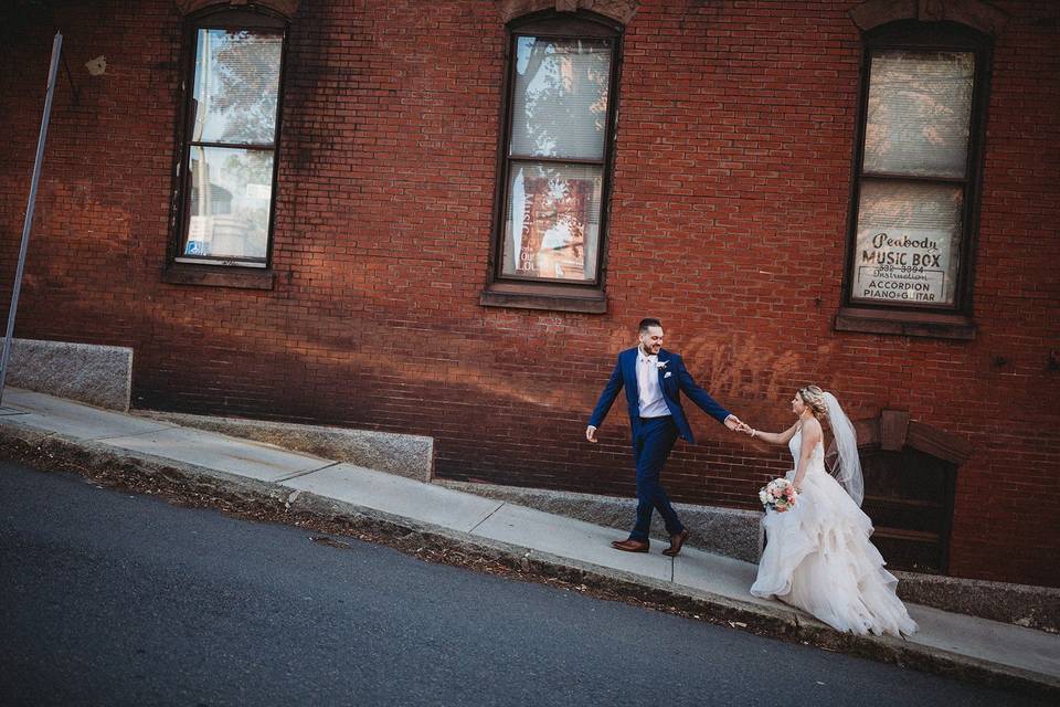 Bride and groom brick wall