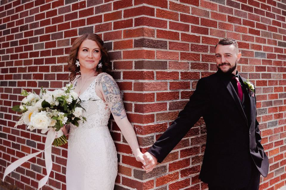 Bride and groom with brick