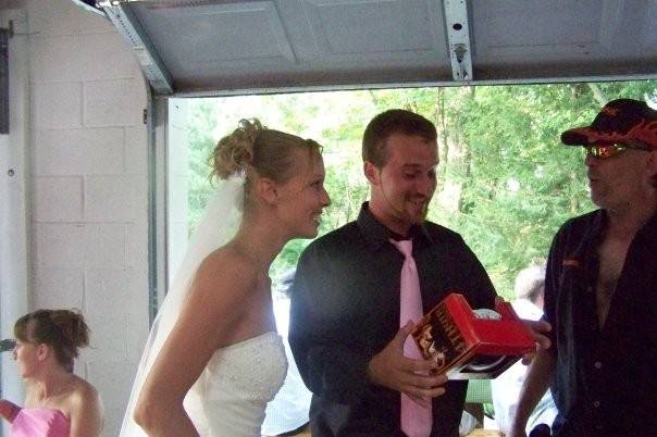 Bride Tasha and her new husband Steven getting a very special signed football from the Bride's Dad