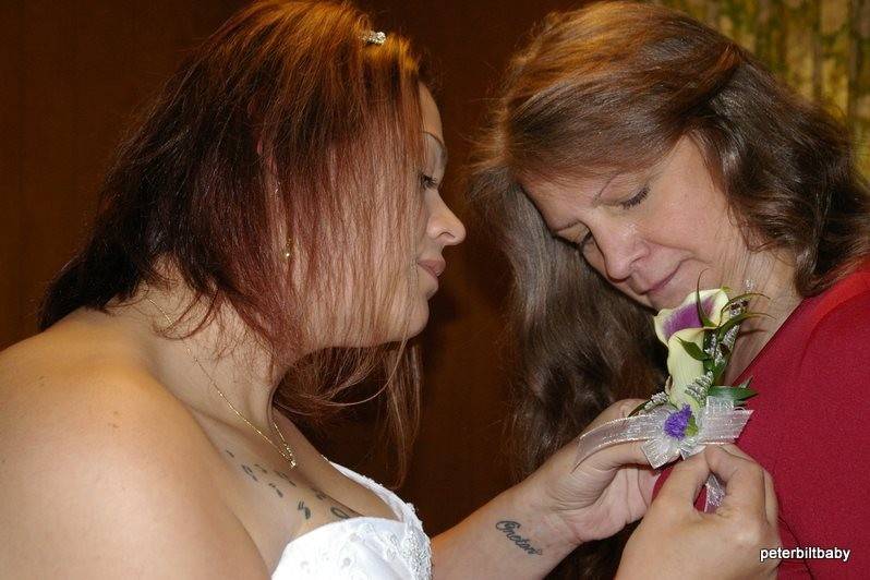 Bride Jamie pinning a corsage on her mother