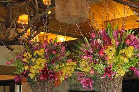 I loved doing this very masculine space overlooking a world class golf course in the foothills of Enchanted Rock. The massive antler chandeliers and beams, stone and leather called for something in keeping with its scale and elegance... I came up with these tall vases. I made around a 60” tall armature of plastic flower buckets and plaster of paris!  I covered them with hundreds of birch branches, pheasant feathers and blooming pussy willow branches...and surrounded them with elk horns, granite pieces and taxidermy mount from friends studios and shops for the display. Spilling out are cymbidium and dendrobium orchid sprays, sumatra lilies and French tulips.  I ended up liking these much better than those I couldn’t buy!My  wonderful client loved what I did for them, having these and other pieces around large platters of food that evening: iconically Texas without apology or kitsch.