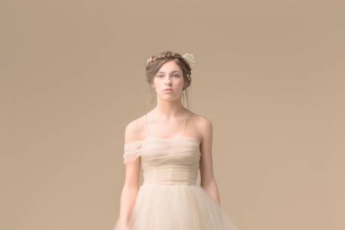 Bella is an ethereal tulle ball gown. The Kate Pankoke signature corset bodice is draped in tulle that falls delicately off of one shoulder.