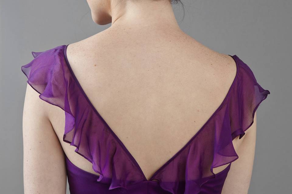 Parkview
Scoop neckline with criss-cross strap and ruffles.