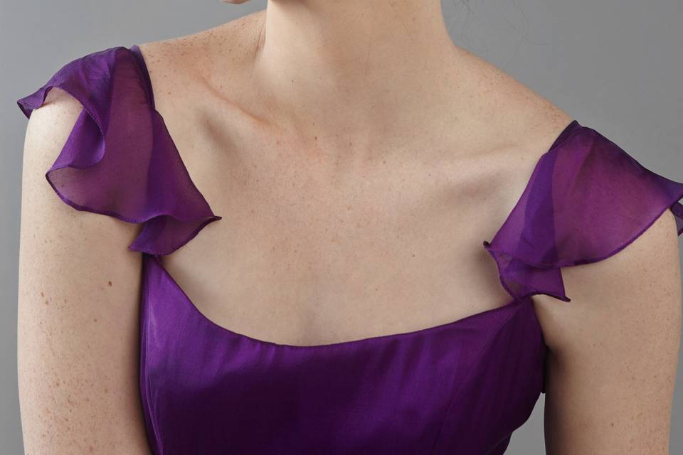 Parkview
Scoop neckline with criss-cross strap and ruffles.