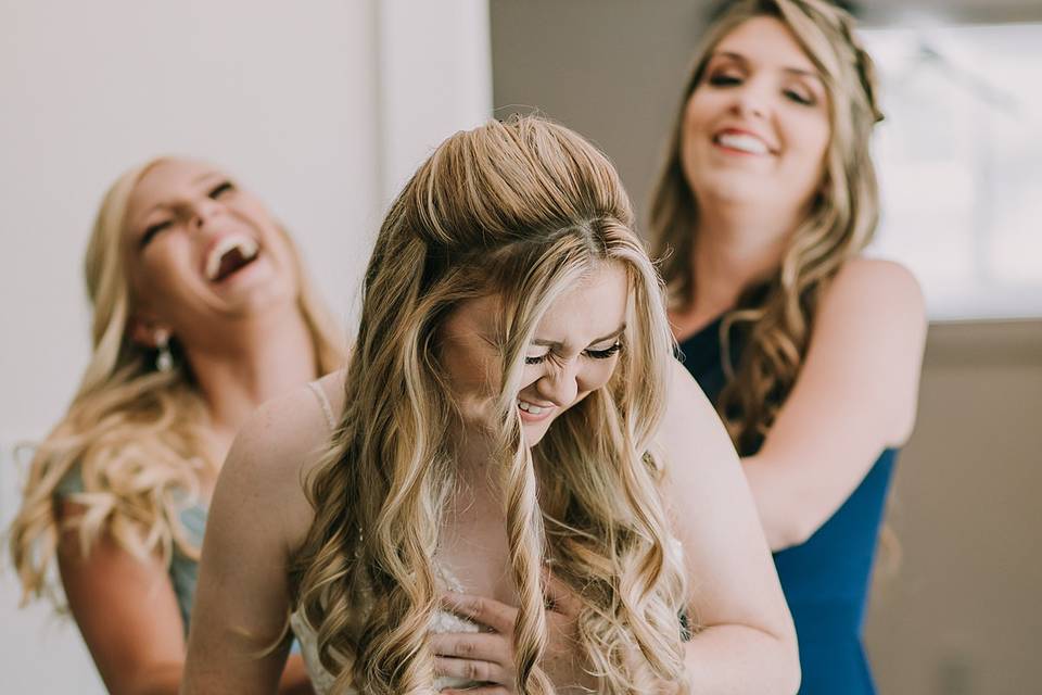 Bride getting in dress