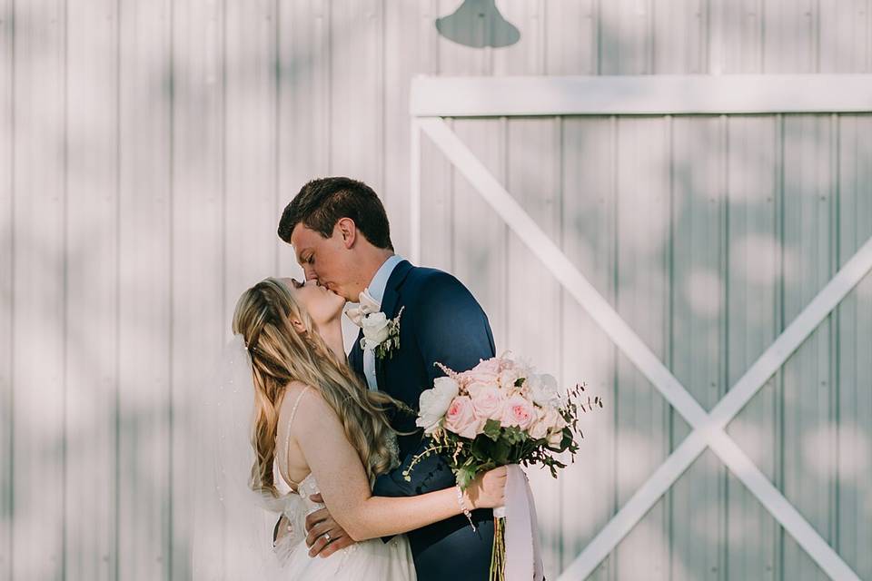 Kiss outside Sugarfoot Barn