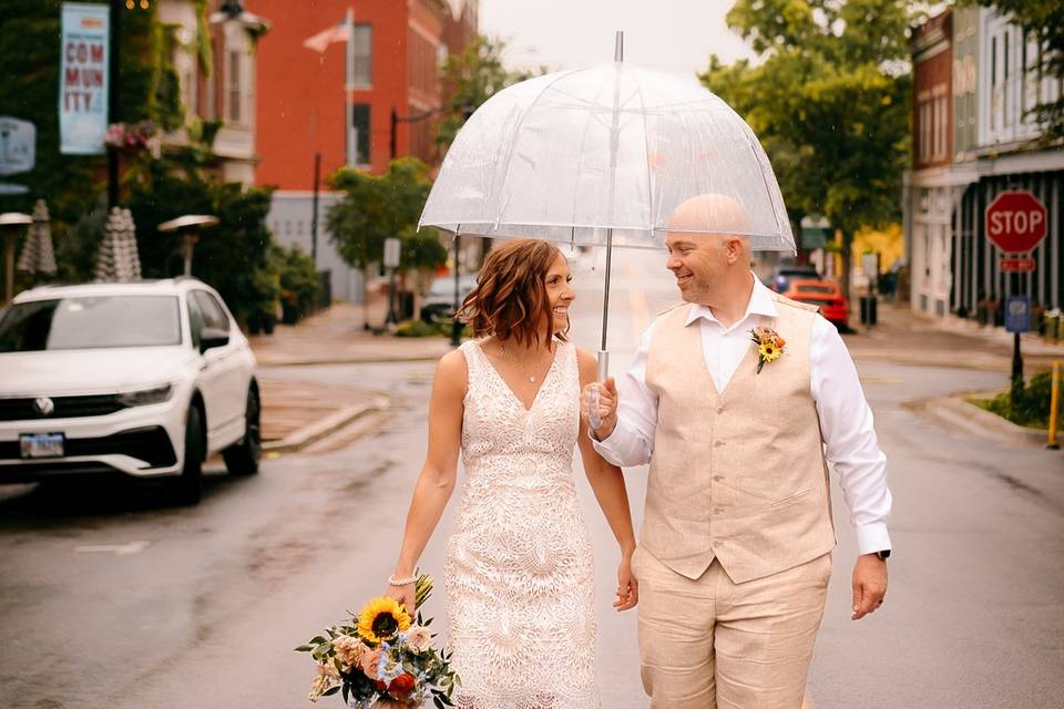 Newlyweds walking in the rain