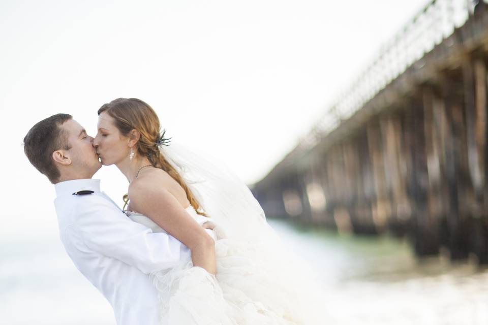 Groom lifting his bride for a kiss