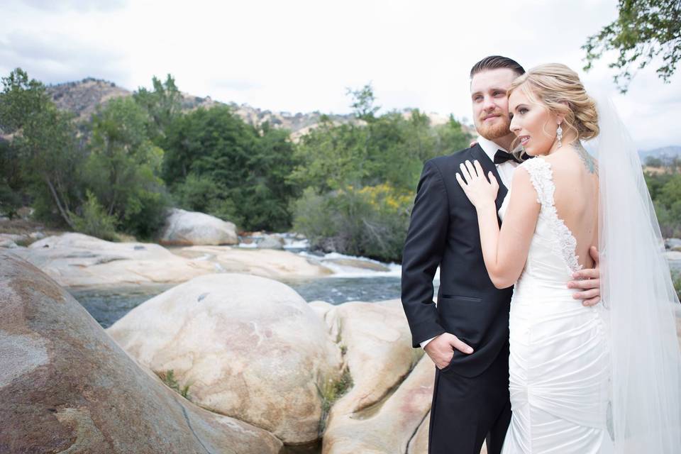 Groom and bride by the rocks