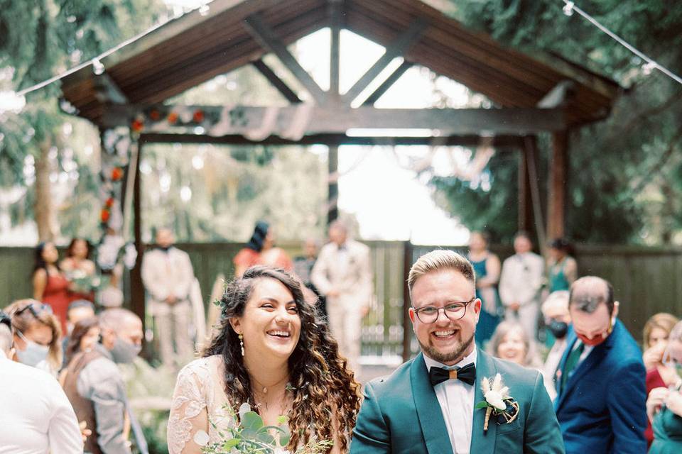 Couple smiling after ceremony.