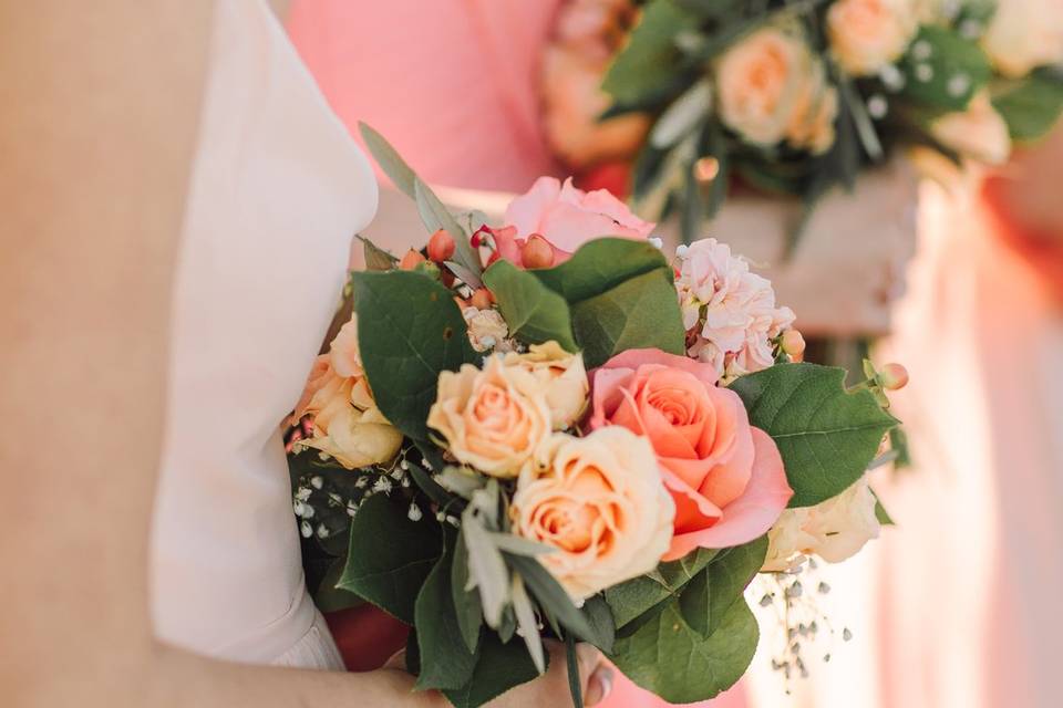 Gold mercury vases filled with dahlias, garden roses, spray roses, hydrangea, dusty miller & eucalyptus! Love the blend of blush, peach & cream together with those green & gold accents.