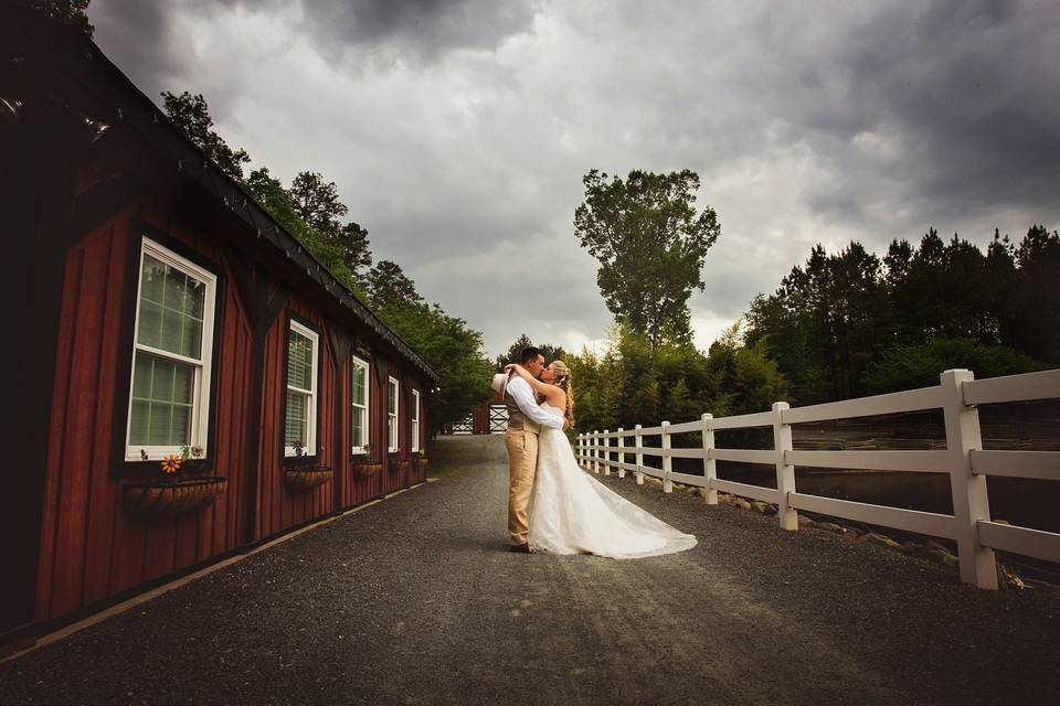 Bride and groom beneath a darkened sky at the Shady Wagon Farm