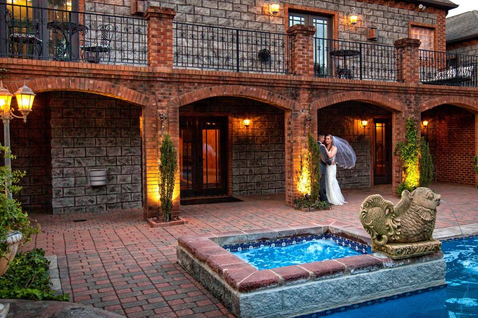 Bride and groom by the pool at Barclay Villa